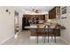 Bright kitchen features dark cabinets, black appliances, tile flooring, and a breakfast bar with seating at 21168 Quesada Ave, Port Charlotte, FL 33952