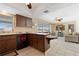 View of the kitchen with dark cabinets and an open floor plan at 21168 Quesada Ave, Port Charlotte, FL 33952