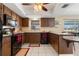 View of the kitchen with dark cabinets, black appliances, tile flooring, and a breakfast bar at 21168 Quesada Ave, Port Charlotte, FL 33952