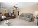 Comfortable living room showcasing neutral carpet, a ceiling fan, and a sitting area at 21168 Quesada Ave, Port Charlotte, FL 33952