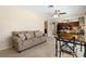 Living room showcasing neutral carpet, ceiling fan, a kitchen view, and sitting area at 21168 Quesada Ave, Port Charlotte, FL 33952
