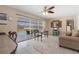 The dining area and living room combination provides versatile space with a sliding glass door view of the pool at 21168 Quesada Ave, Port Charlotte, FL 33952