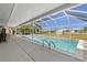 Beautiful screened-in pool area with comfortable seating providing an ideal space for outdoor leisure at 21168 Quesada Ave, Port Charlotte, FL 33952