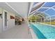 Inviting screened-in pool with a covered patio and comfortable outdoor seating area for relaxation and entertainment at 21168 Quesada Ave, Port Charlotte, FL 33952