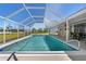 Large screened-in pool with clear blue water, offering a refreshing escape and outdoor enjoyment at 21168 Quesada Ave, Port Charlotte, FL 33952
