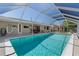 Relaxing screened-in pool with clear blue water, offering a refreshing escape and outdoor enjoyment at 21168 Quesada Ave, Port Charlotte, FL 33952