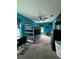 Bright bedroom featuring a bunk bed, desk, and playful blue walls with gaming-themed decor at 22223 Seyburn Ter, Port Charlotte, FL 33954