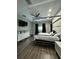 Modern bedroom with a stylish four-poster bed, dark accents, and wood-look flooring at 22223 Seyburn Ter, Port Charlotte, FL 33954