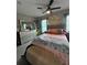 A bedroom showcasing a comfortable bed, mirrored dresser, and stylish decor with ample natural light at 22223 Seyburn Ter, Port Charlotte, FL 33954