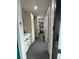 Hallway view with a modern bathroom and a bedroom beyond, showcasing the home's layout at 22223 Seyburn Ter, Port Charlotte, FL 33954