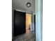 Hallway featuring a modern sliding barn door and stylish wood-look tile flooring at 22223 Seyburn Ter, Port Charlotte, FL 33954