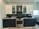 Modern kitchen with stainless steel appliances, two-toned cabinets, and stylish backsplash at 22223 Seyburn Ter, Port Charlotte, FL 33954