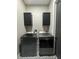 Laundry room with modern washer and dryer, storage cabinets, and designer patterned tile flooring at 22223 Seyburn Ter, Port Charlotte, FL 33954