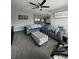 Cozy living room featuring a large sectional sofa, plush carpeting, and plenty of natural light at 22223 Seyburn Ter, Port Charlotte, FL 33954