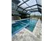Backyard view showing a screened in pool and spa with an outdoor kitchen at 22223 Seyburn Ter, Port Charlotte, FL 33954