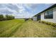 Spacious backyard with a lush lawn and view of a pond in the distance at 2232 Bonito Way, Port Charlotte, FL 33953