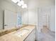 Bright bathroom featuring a granite vanity top, undermount sink, and a large mirror at 2232 Bonito Way, Port Charlotte, FL 33953