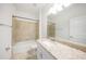 Bathroom with large mirror, bathtub shower combo, and granite counters at 2232 Bonito Way, Port Charlotte, FL 33953
