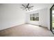 Spacious bedroom featuring natural light, ceiling fan, and neutral carpeting at 2232 Bonito Way, Port Charlotte, FL 33953