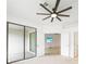 Light and bright bedroom with ceiling fan, leading to patio with sliding glass door at 2232 Bonito Way, Port Charlotte, FL 33953