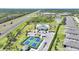 Aerial view of a community pool with lush landscaping, and tennis courts at 2232 Bonito Way, Port Charlotte, FL 33953
