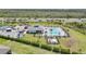 Aerial view of the community pool with lounge chairs and nearby tennis courts at 2232 Bonito Way, Port Charlotte, FL 33953