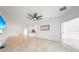 Expansive living room featuring tile flooring, a ceiling fan, and an open layout into the kitchen at 2232 Bonito Way, Port Charlotte, FL 33953