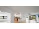 Open-concept living room flowing into the kitchen, featuring bright white walls and neutral tile flooring at 2232 Bonito Way, Port Charlotte, FL 33953