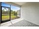 Screened-in lanai with brick flooring and views of the backyard at 2232 Bonito Way, Port Charlotte, FL 33953