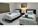 Cozy bedroom featuring two twin beds with stylish decor and towels at 23442 Harper Ave, Punta Gorda, FL 33980