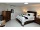 Bright bedroom with white tiled floors and modern furnishings at 23442 Harper Ave, Punta Gorda, FL 33980