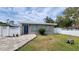 Charming single story home with a blue front door and colorful brick paver driveway at 23442 Harper Ave, Punta Gorda, FL 33980