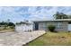 Charming single story home with a blue front door and colorful brick paver driveway at 23442 Harper Ave, Punta Gorda, FL 33980