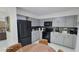 Updated kitchen features gray cabinets and modern black appliances at 23442 Harper Ave, Punta Gorda, FL 33980