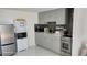 Modern kitchen featuring gray cabinets, stainless steel appliances, and sleek countertops for a contemporary cooking experience at 23442 Harper Ave, Punta Gorda, FL 33980