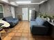 Relaxing bonus room featuring comfortable seating, tiled floors, a vintage refrigerator, and a 'Soda' sign at 23442 Harper Ave, Punta Gorda, FL 33980
