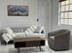 Cozy living room with elegant gray sofa, stylish chair, modern coffee table, and marbled tile flooring at 23442 Harper Ave, Punta Gorda, FL 33980