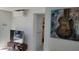 Bright living room showcases a TV on a wooden stand with modern art and a mini-split unit installed at 23442 Harper Ave, Punta Gorda, FL 33980