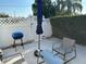 Inviting outdoor patio area with comfortable seating, a grill, and a serene, shaded ambiance at 23442 Harper Ave, Punta Gorda, FL 33980