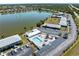 Aerial view of the community pool and surrounding residential buildings by the lake at 25225 Rampart Blvd # 205, Punta Gorda, FL 33983