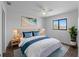 Comfortable primary bedroom with white walls, ceiling fan, nice window, and stylish furnishings at 25225 Rampart Blvd # 205, Punta Gorda, FL 33983