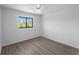 Bright bedroom features a ceiling fan, wood-look floors, and a window with lush views at 25225 Rampart Blvd # 205, Punta Gorda, FL 33983