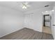 Bright bedroom featuring a ceiling fan, wood-look floors, spacious closet, and in-unit laundry at 25225 Rampart Blvd # 205, Punta Gorda, FL 33983