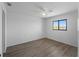 Bright bedroom featuring white walls, a ceiling fan, and a window at 25225 Rampart Blvd # 205, Punta Gorda, FL 33983