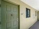 Close-up of the front door of unit 205 with olive green color and decorative hardware at 25225 Rampart Blvd # 205, Punta Gorda, FL 33983