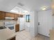Efficient kitchen featuring tiled floor, white appliances, and good natural light at 25225 Rampart Blvd # 205, Punta Gorda, FL 33983
