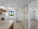 Bright kitchen with white cabinets, window, tile floors, and ceiling fan at 25225 Rampart Blvd # 205, Punta Gorda, FL 33983