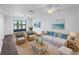 Cozy living room with wicker furniture, coastal decor, and a water view from the lanai at 25225 Rampart Blvd # 205, Punta Gorda, FL 33983