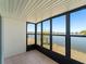 Enclosed sunroom with tile floor offers panoramic views of the lake and surrounding landscape at 25225 Rampart Blvd # 205, Punta Gorda, FL 33983