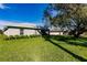 Well-maintained backyard featuring a lush lawn and mature trees for added privacy at 27260 Porto Nacional Dr, Punta Gorda, FL 33983